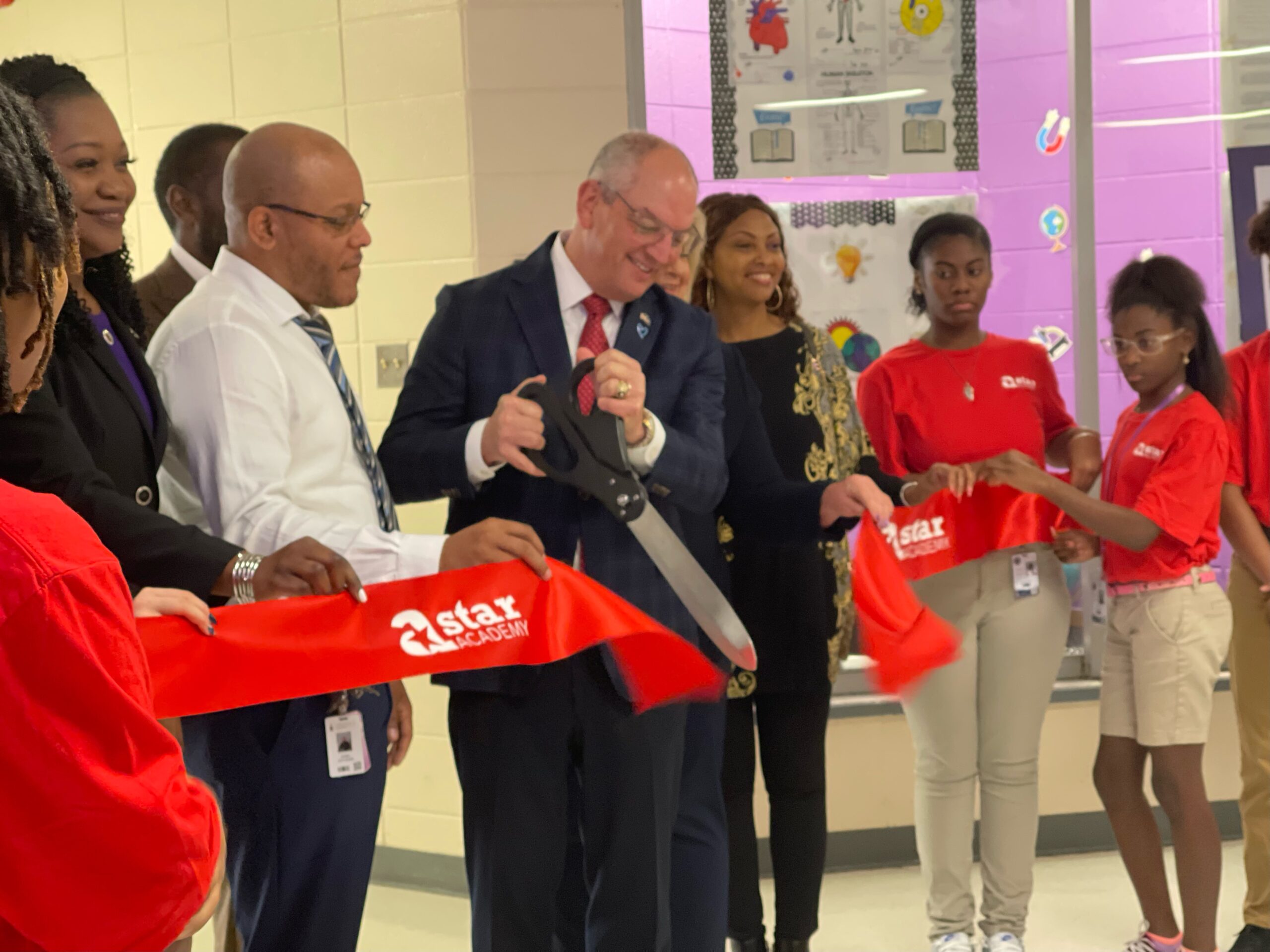 Governor John Bel Edwards cutting the ribbon at a Star Academy launch in Tangipahoa Parish, Louisiana